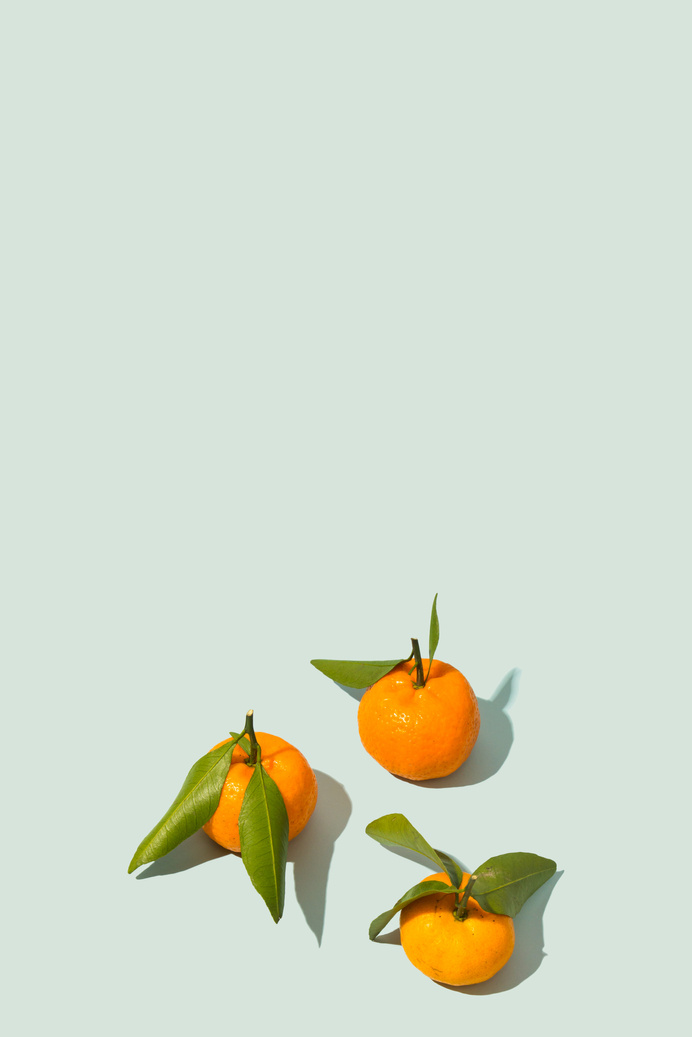 Oranges with Leaves on Light Background